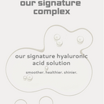 Skincare sheet mask with 'our signature complex' and 'our signature hyaluronic acid solution' text on a light gray background.