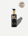 Black bottle of Madme Liquid Gold Oil with a gold cap on a white background, featuring an award badge.