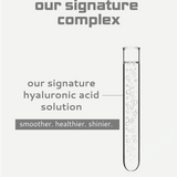 Test tube with clear liquid labeled 'our signature hyaluronic acid solution' on a light gray background.