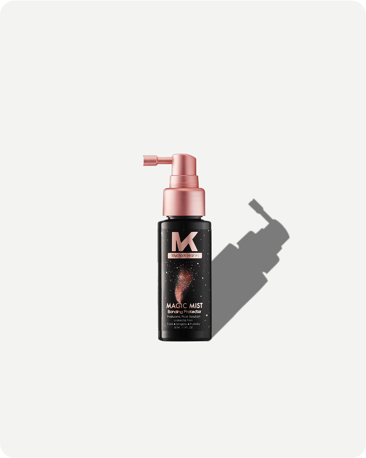 Black spray bottle with pink top on a white background, our magic mist travel size