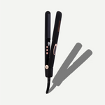 Black hair straightener with rose gold accents on a white background