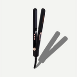 Black hair straightener with rose gold accents on a white background