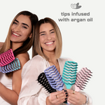 Two women holding colorful hairbrushes with 'tips infused with argan oil' text on a white background.
