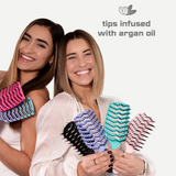 Two women holding colorful hairbrushes with 'tips infused with argan oil' text on a white background.