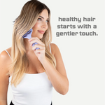 Woman using a hairbrush with text 'healthy hair starts with a gentler touch' on a white background