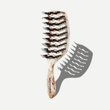 Hairbrush with tortoiseshell pattern on a white background