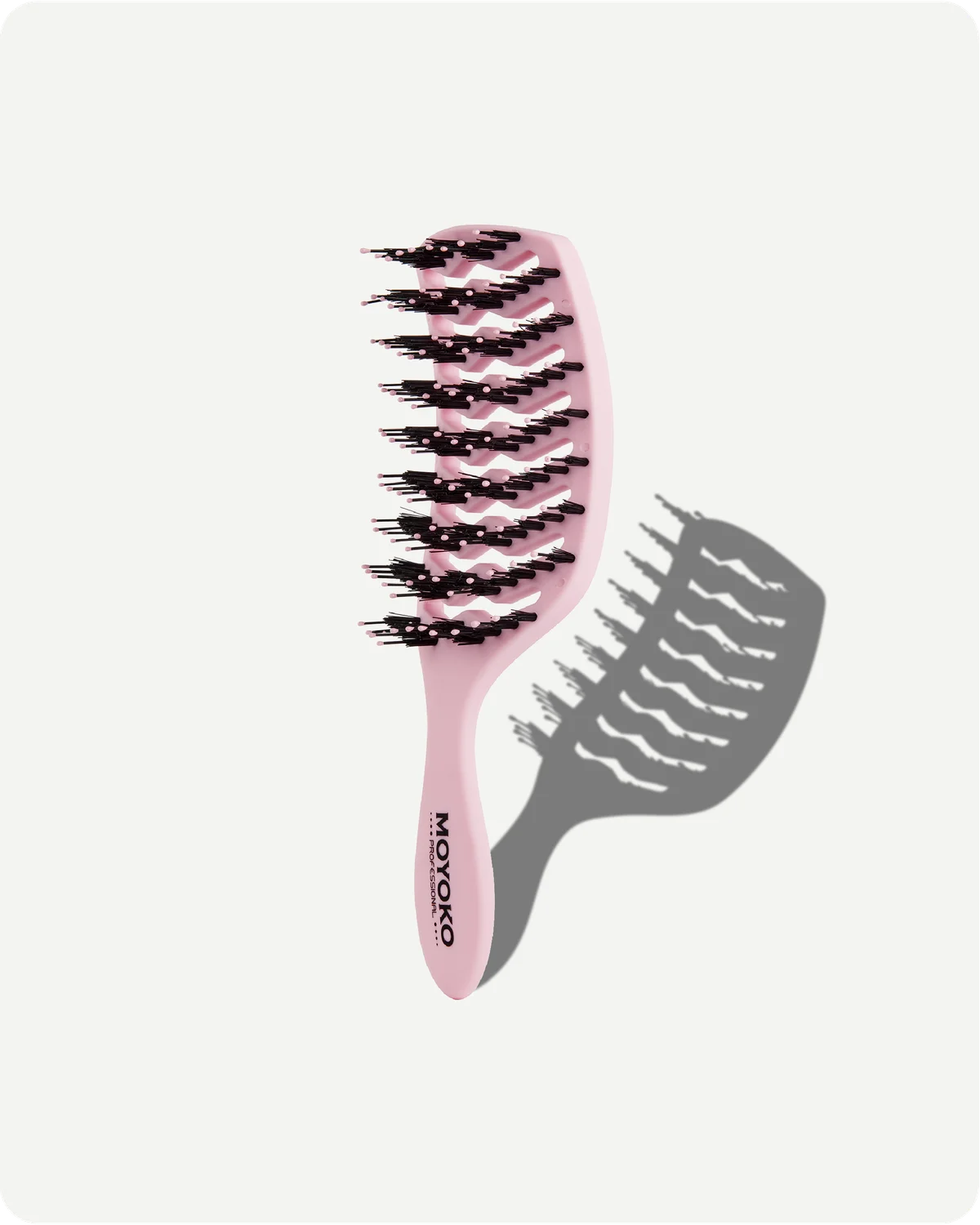 Pink hairbrush with black bristles on a white background