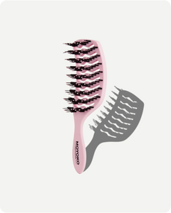 Pink hairbrush with black bristles on a white background