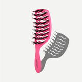 Pink hairbrush with black bristles on a white background