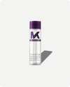 Tone and Treat conditioner bottle with purple cap and white label on a light gray background